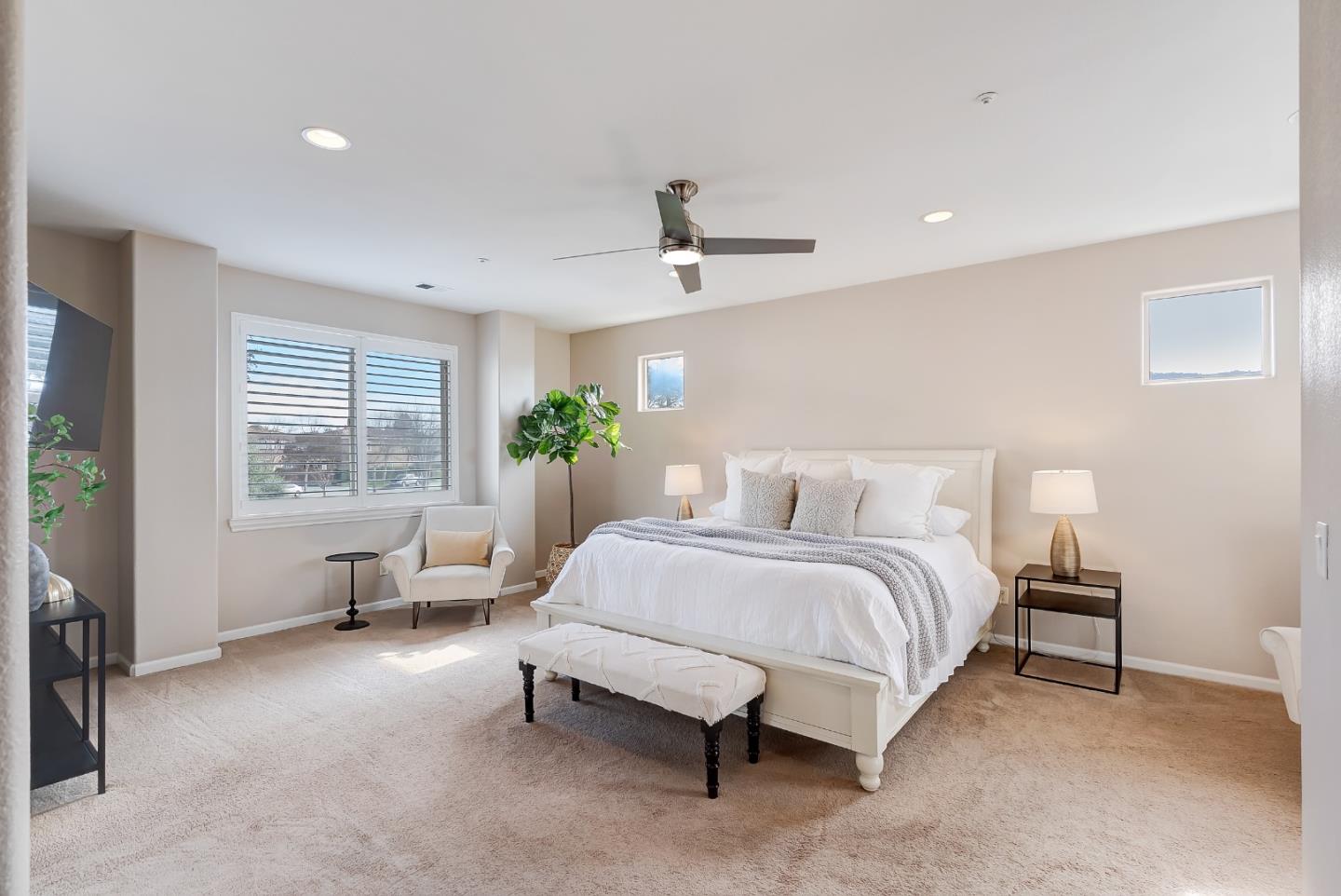 8850 Morey Way Gilroy, CA 95020 - Photo 22 of 34 a spacious bedroom with a bed couch and windows