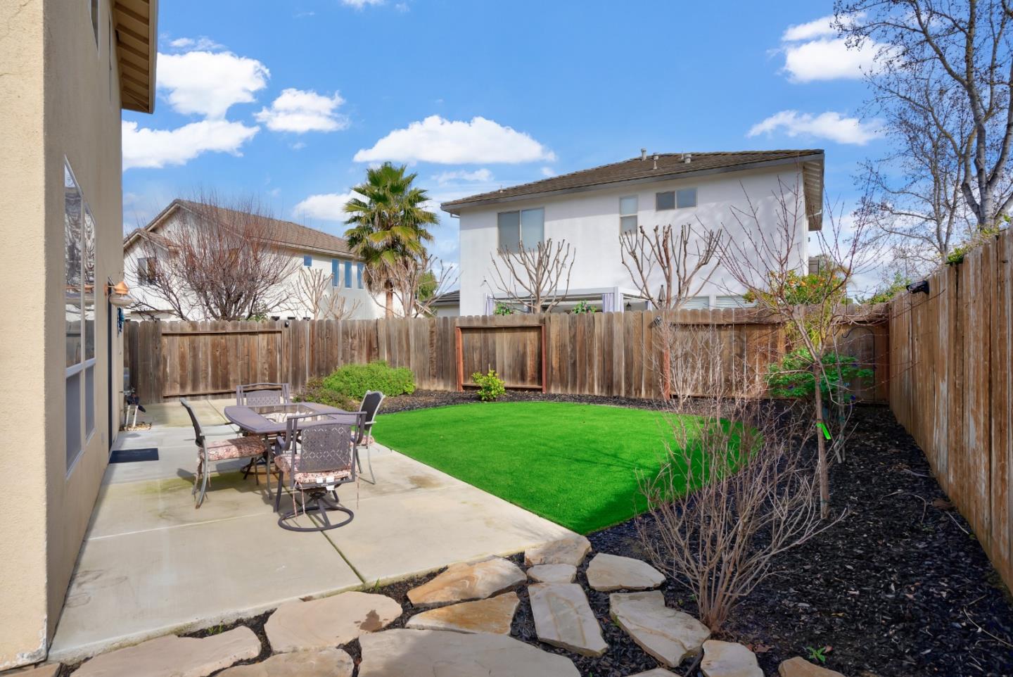 8850 Morey Way Gilroy, CA 95020 - Photo 30 of 34 a view of a patio with table and chairs and potted plants