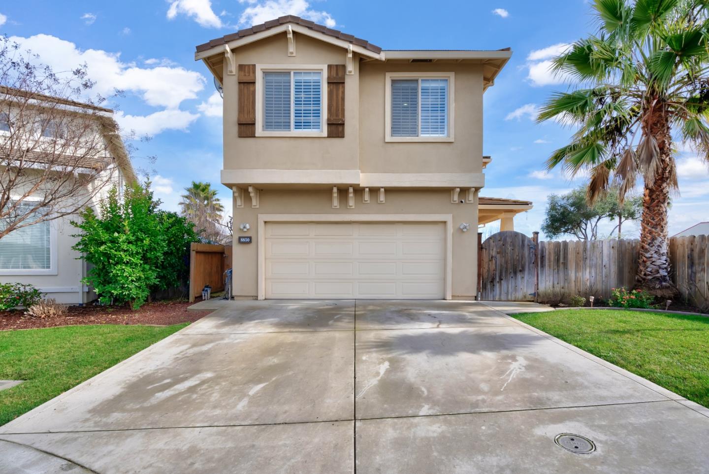 8850 Morey Way Gilroy, CA 95020 - Photo 3 of 34 a front view of a house with a yard and garage