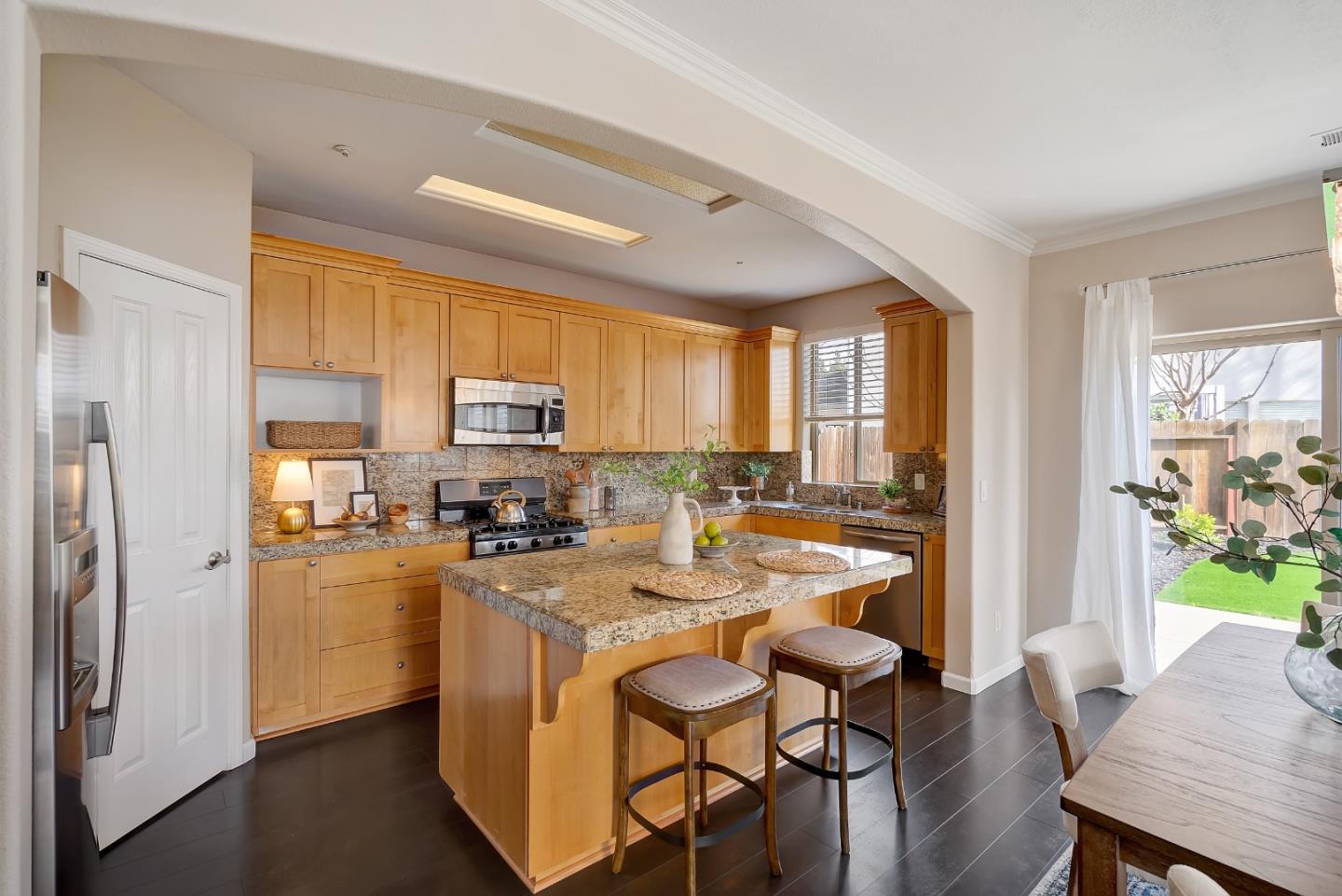 8850 Morey Way Gilroy, CA 95020 - Photo 10 of 34 a kitchen with refrigerator a stove and furniture