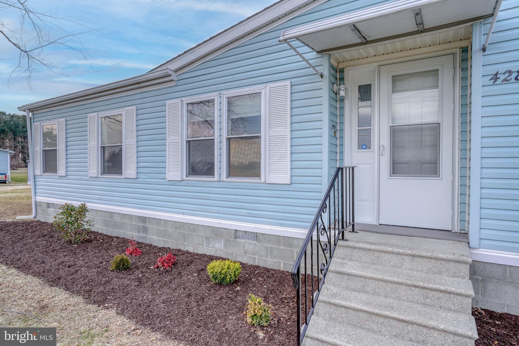 4285 Carpenter Bridge Road Felton, DE 19943 - Photo 11 of 45 a view of a house with chairs and wooden fence