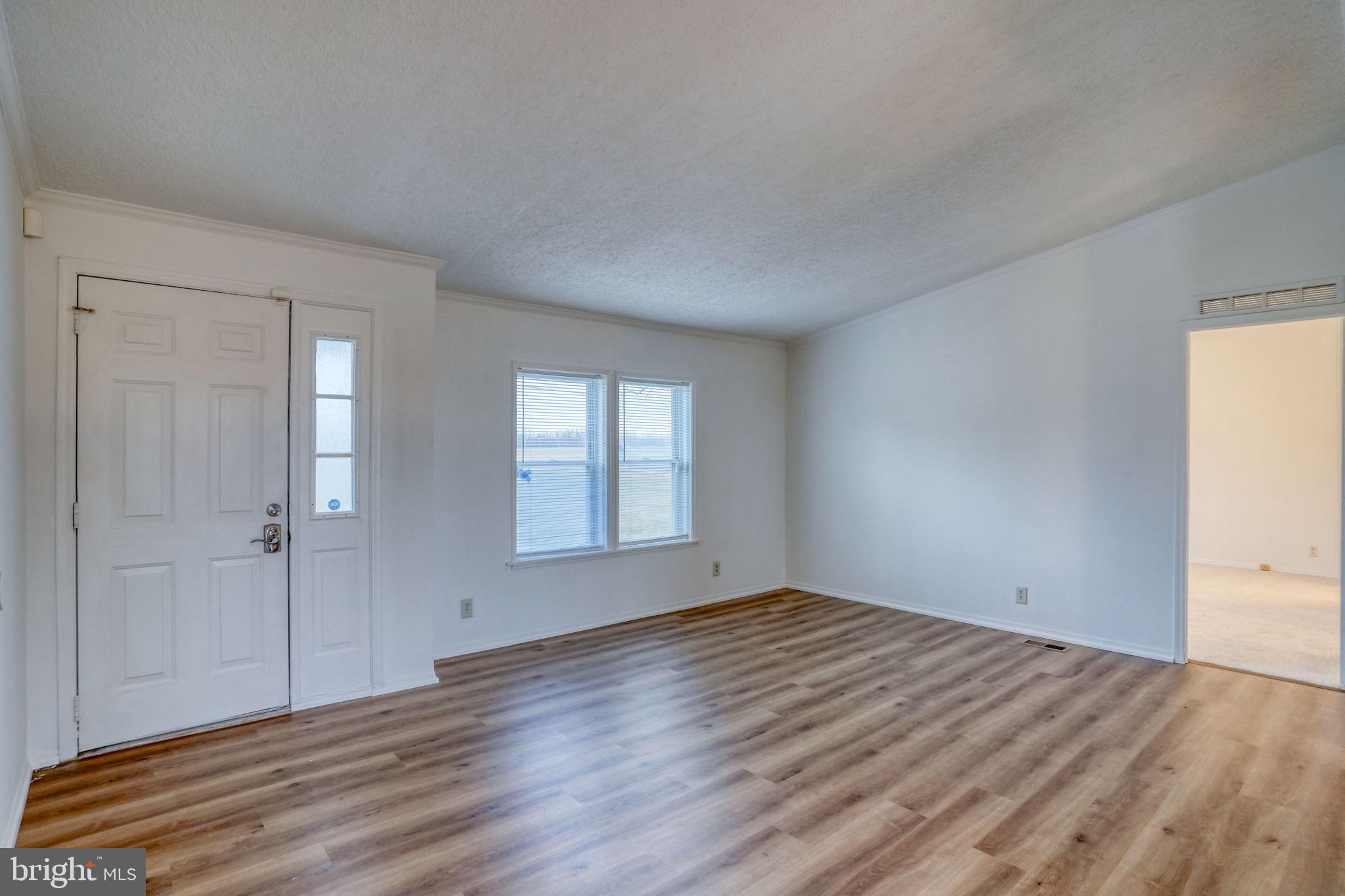 4285 Carpenter Bridge Road Felton, DE 19943 - Photo 13 of 45 a view of empty room with wooden floor and fan