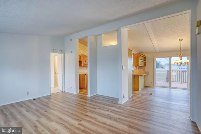 a kitchen with a refrigerator and a stove top oven