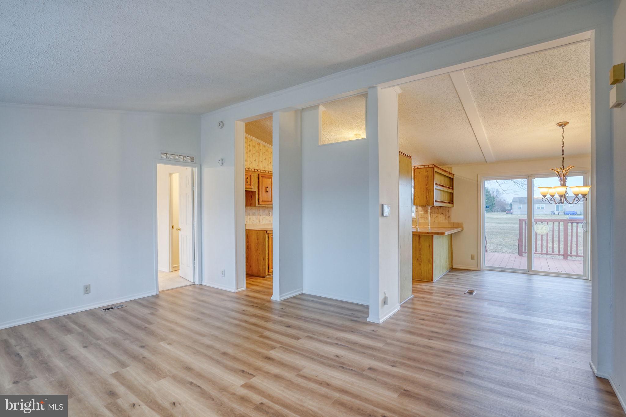 4285 Carpenter Bridge Road Felton, DE 19943 - Photo 16 of 45 a view of a big room with wooden floor and windows