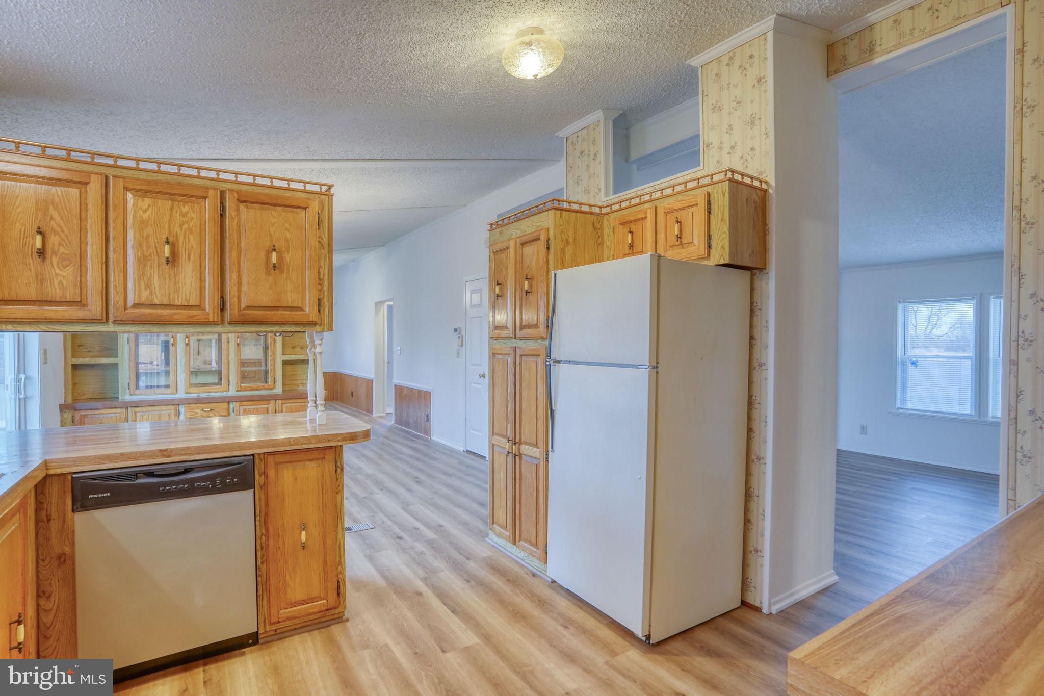 4285 Carpenter Bridge Road Felton, DE 19943 - Photo 17 of 45 a kitchen with a refrigerator and a stove top oven