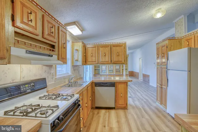 a kitchen with stainless steel appliances granite countertop a stove and a sink