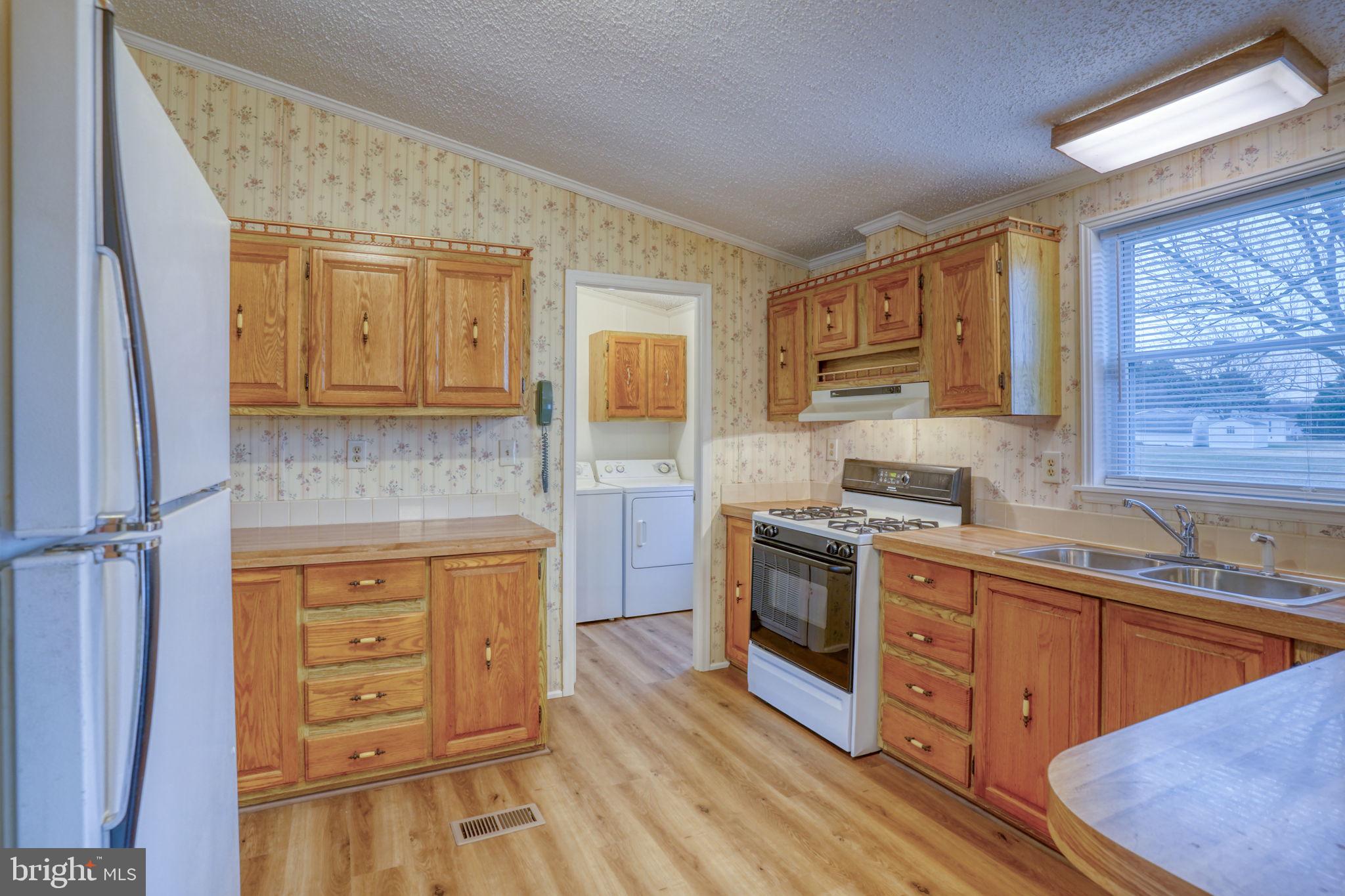 4285 Carpenter Bridge Road Felton, DE 19943 - Photo 19 of 45 a kitchen with stainless steel appliances granite countertop a stove and a sink