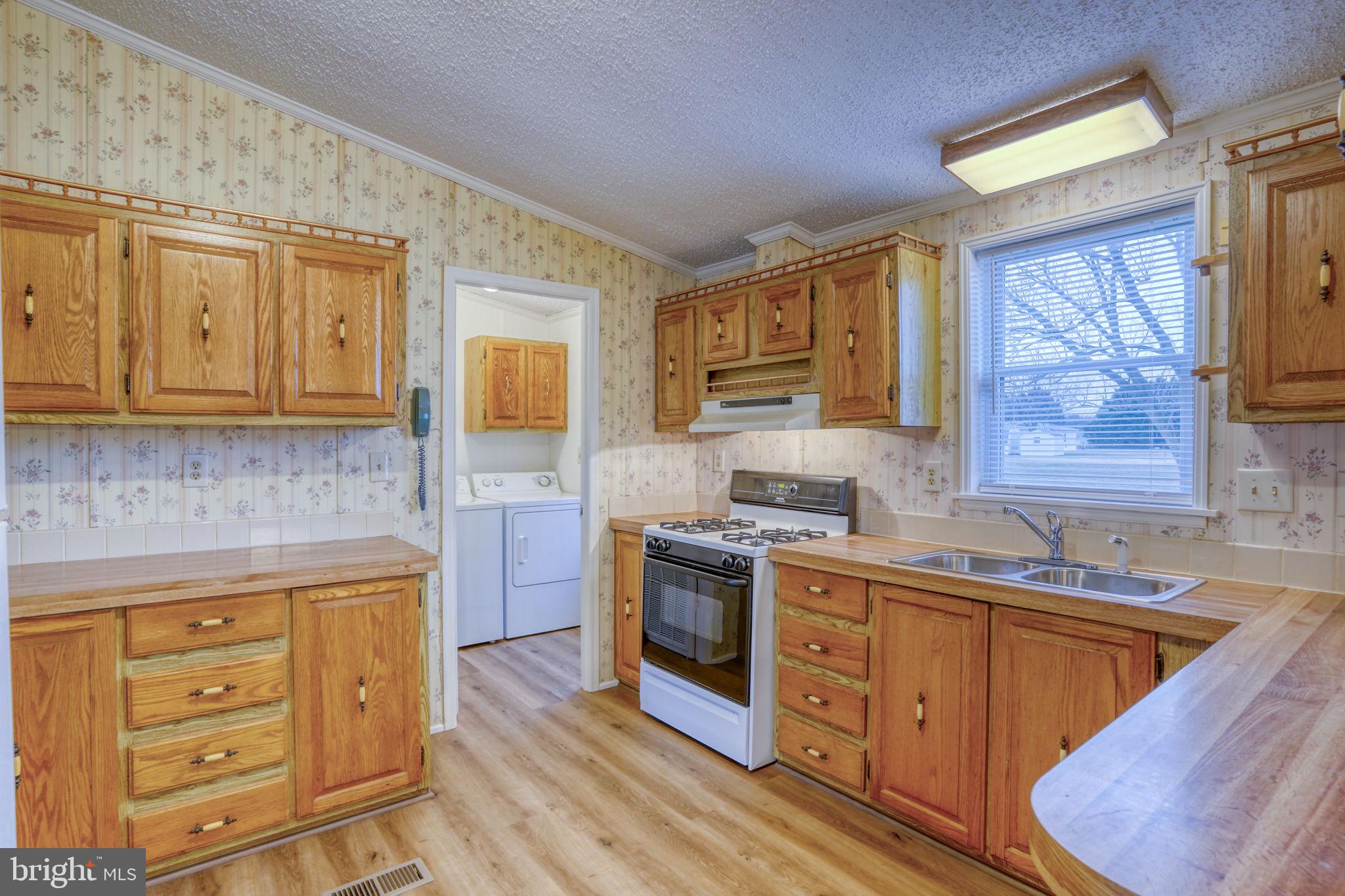 4285 Carpenter Bridge Road Felton, DE 19943 - Photo 21 of 45 a kitchen with stainless steel appliances granite countertop a sink stove and cabinets