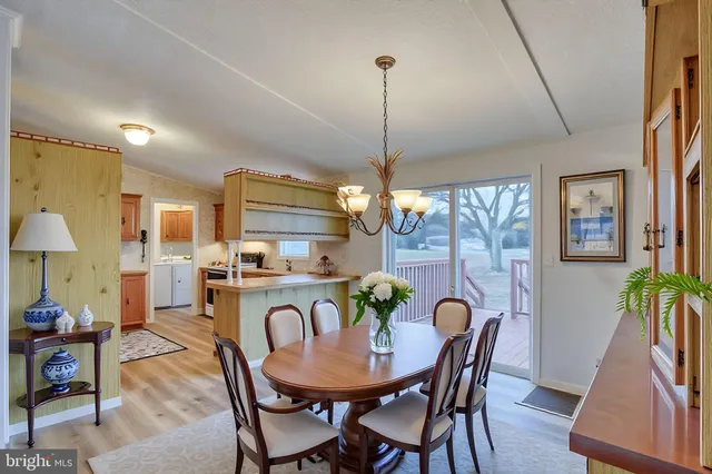 a view of a room with wooden floor and a floor to ceiling window