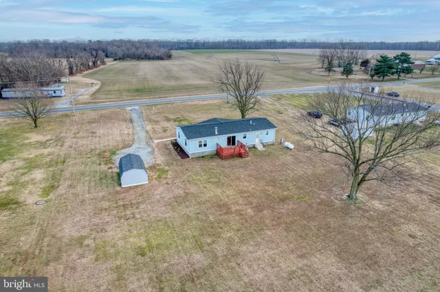 a view of a house with a yard and wooden fence