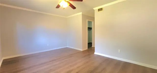 a kitchen with kitchen island a sink cabinets and wooden floor