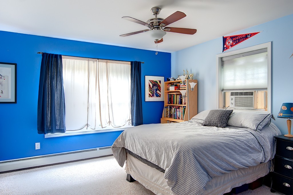 64 Farm Pond Road Oakham, MA 01068 - Photo 13 of 20 a bedroom with a large bed and a chandelier