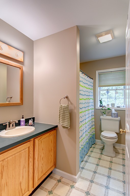 64 Farm Pond Road Oakham, MA 01068 - Photo 14 of 20 a bathroom with a granite countertop toilet sink and mirror