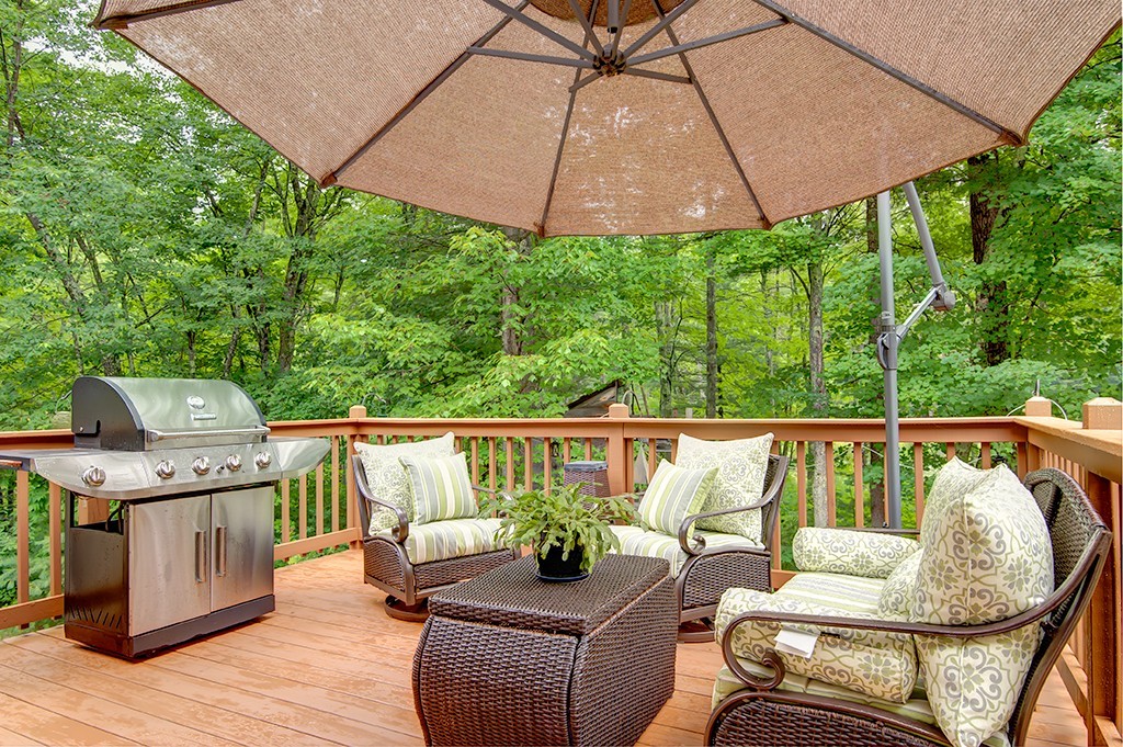 64 Farm Pond Road Oakham, MA 01068 - Photo 16 of 20 a balcony with furniture and umbrella