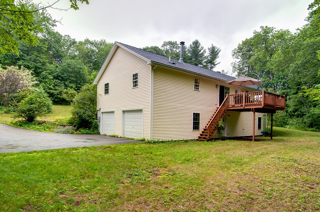 64 Farm Pond Road Oakham, MA 01068 - Photo 17 of 20 a house with garden in front of it