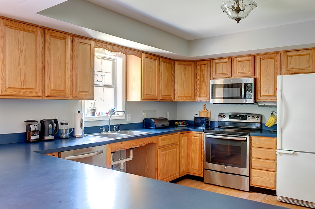 64 Farm Pond Road Oakham, MA 01068 - Photo 8 of 20 a kitchen with stainless steel appliances granite countertop a stove a sink dishwasher a refrigerator and a microwave oven with wooden floor