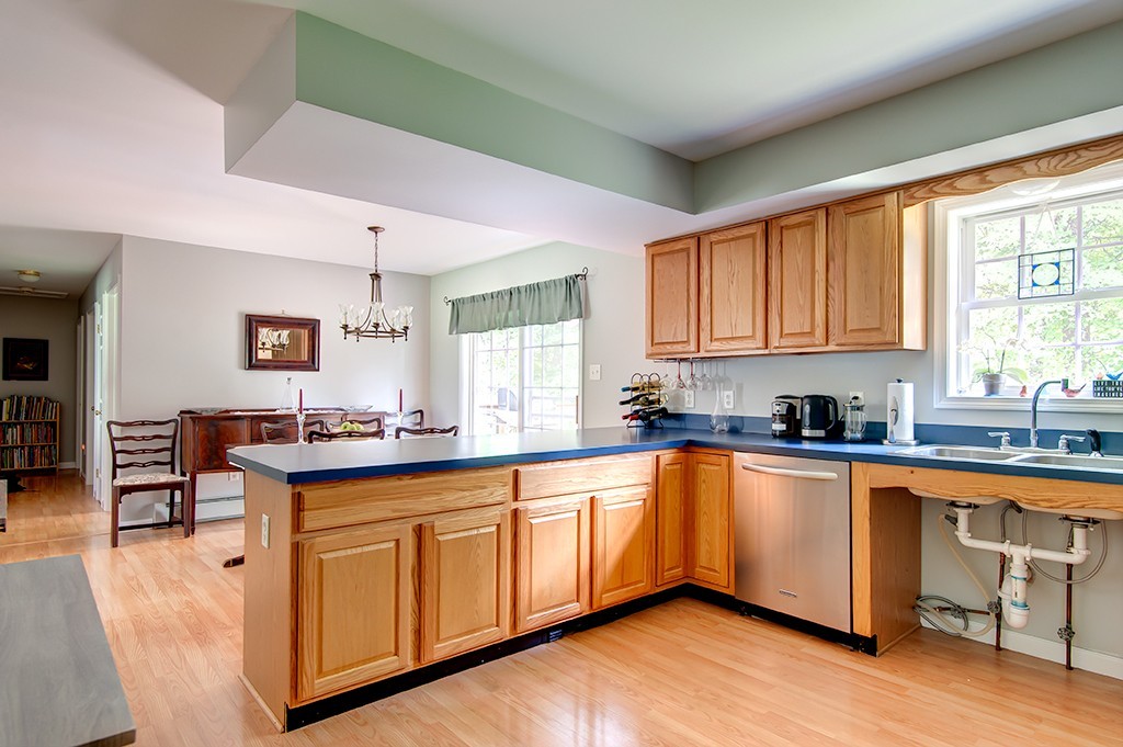 64 Farm Pond Road Oakham, MA 01068 - Photo 9 of 20 a kitchen with stainless steel appliances granite countertop a stove top oven a sink dishwasher and cabinets with wooden floor
