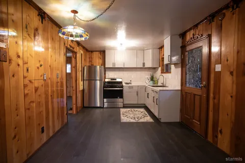 a kitchen with refrigerator and cabinets