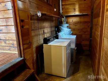 a kitchen with kitchen island wooden floors and stainless steel appliances