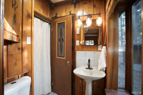 a bathroom with a sink a mirror and a shower