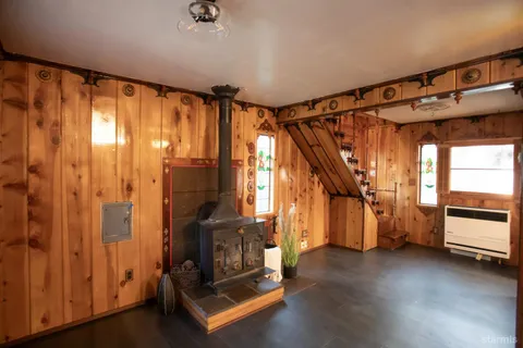 a view of an empty room with stairs and furniture