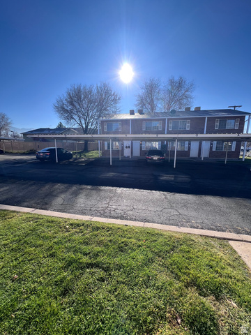 556 North Fairfield Road, Unit A1 Layton, UT 84041 - Photo 1 of 1 Traditional-style home featuring covered parking, a front yard, and a chimney
