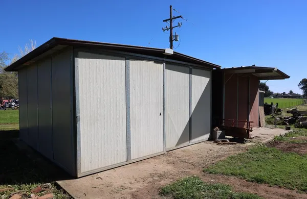 a view of a lake with a bench and trees