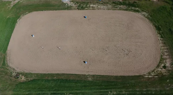 a bedroom with a bed a flat screen tv and a large window with the outer view