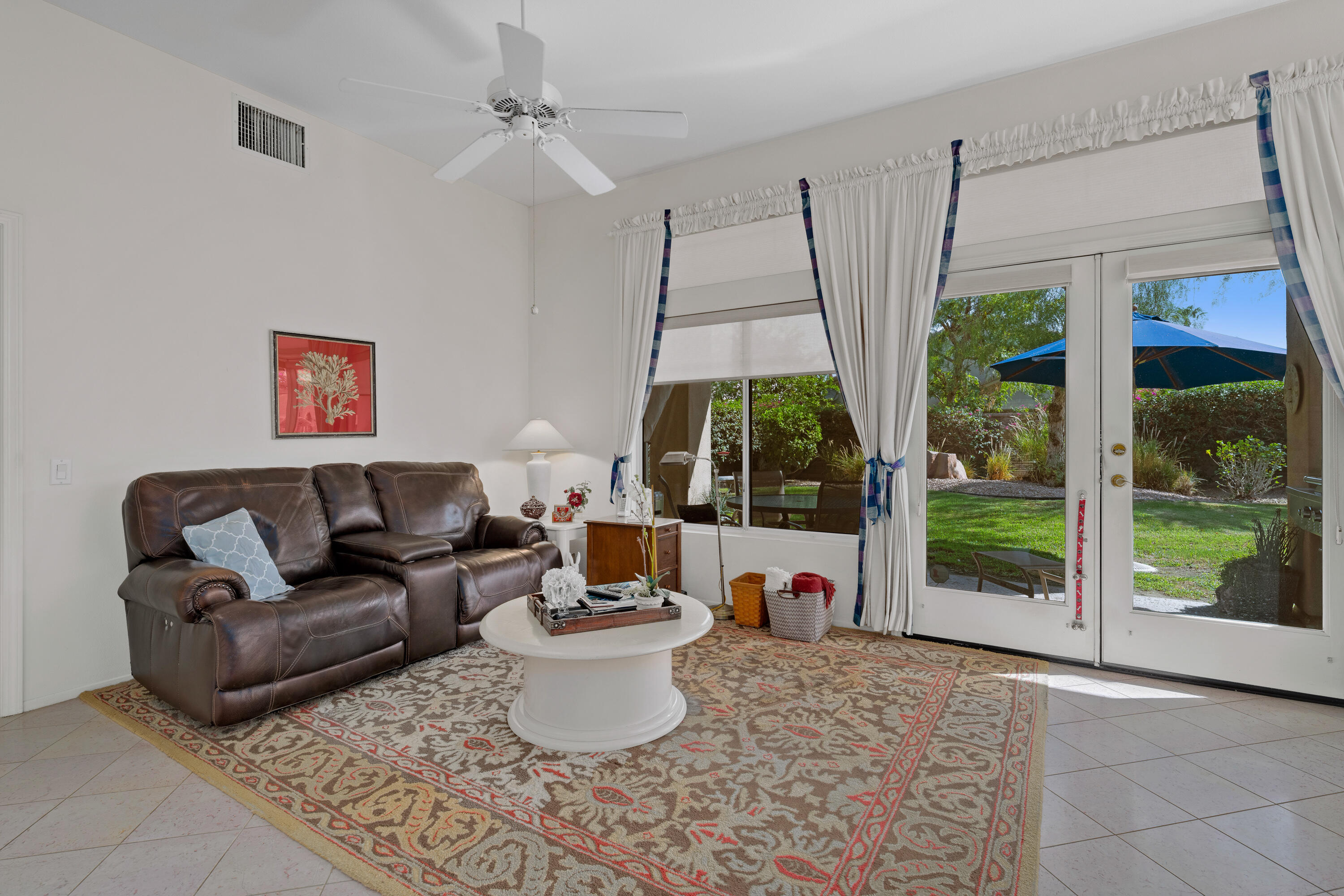 78274 Rainbow Drive Palm Desert, CA 92211 - Photo 11 of 24 a living room with furniture and a large window