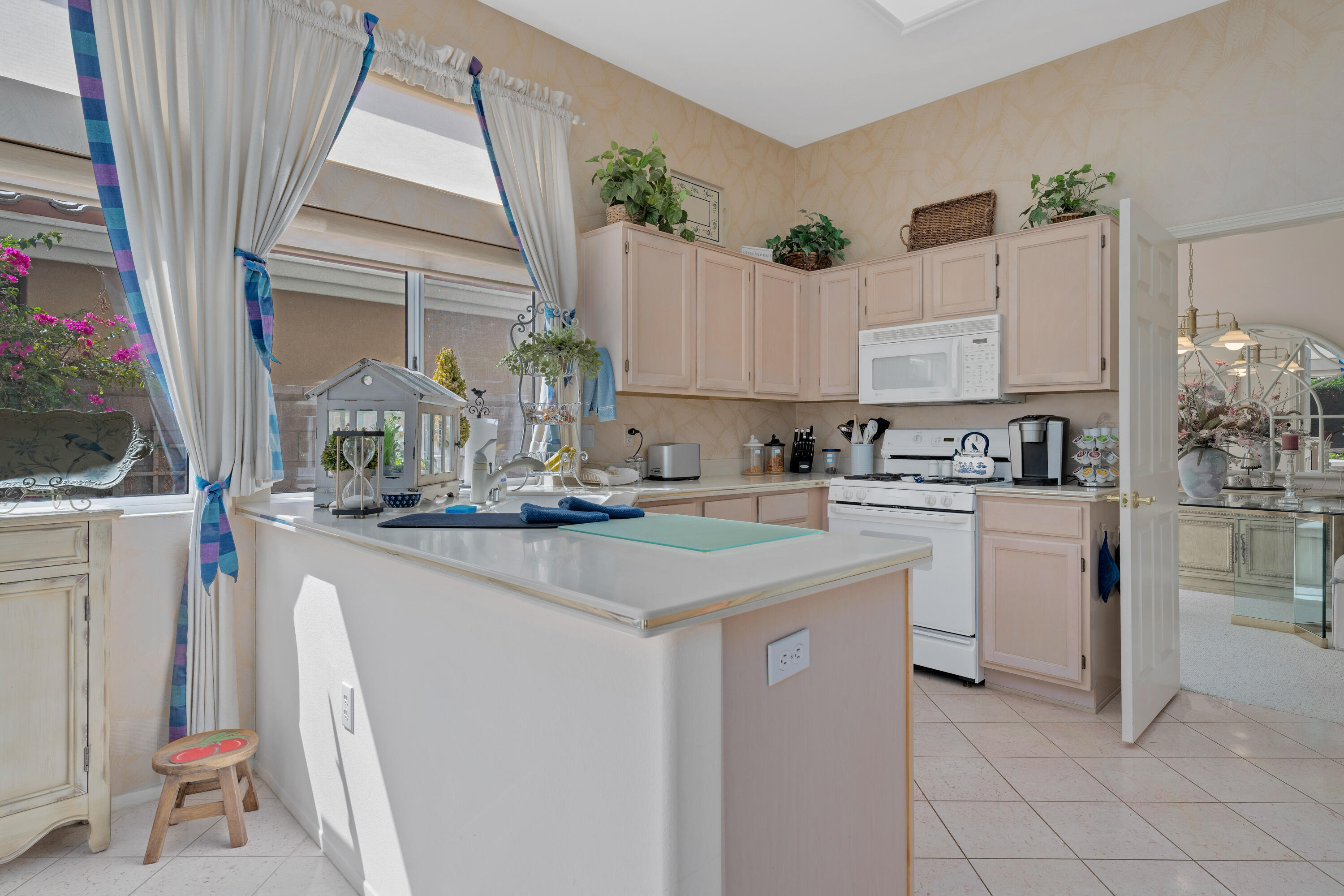 78274 Rainbow Drive Palm Desert, CA 92211 - Photo 14 of 24 a kitchen with appliances a sink and cabinets