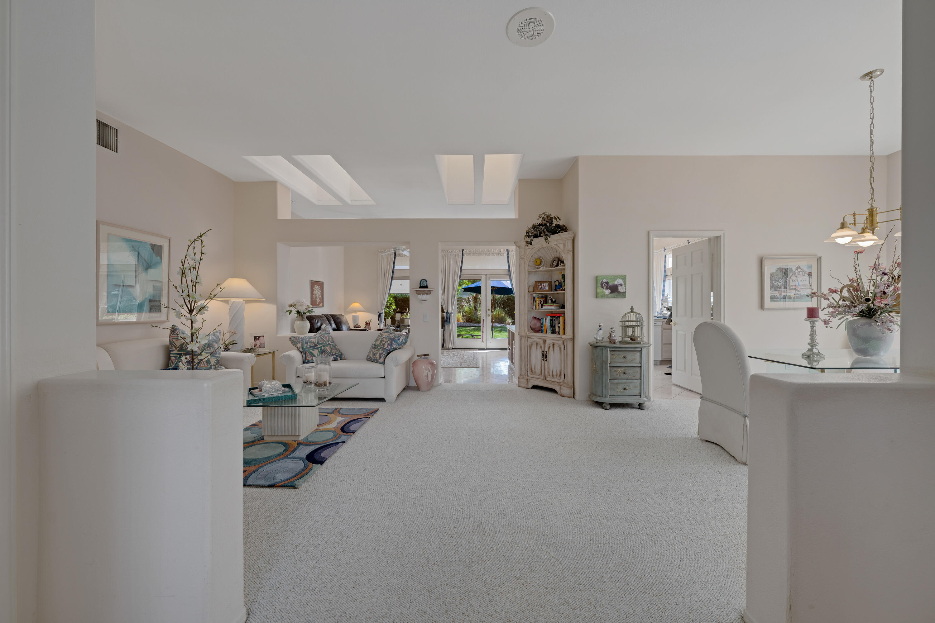 78274 Rainbow Drive Palm Desert, CA 92211 - Photo 7 of 24 a living room with furniture and a chandelier