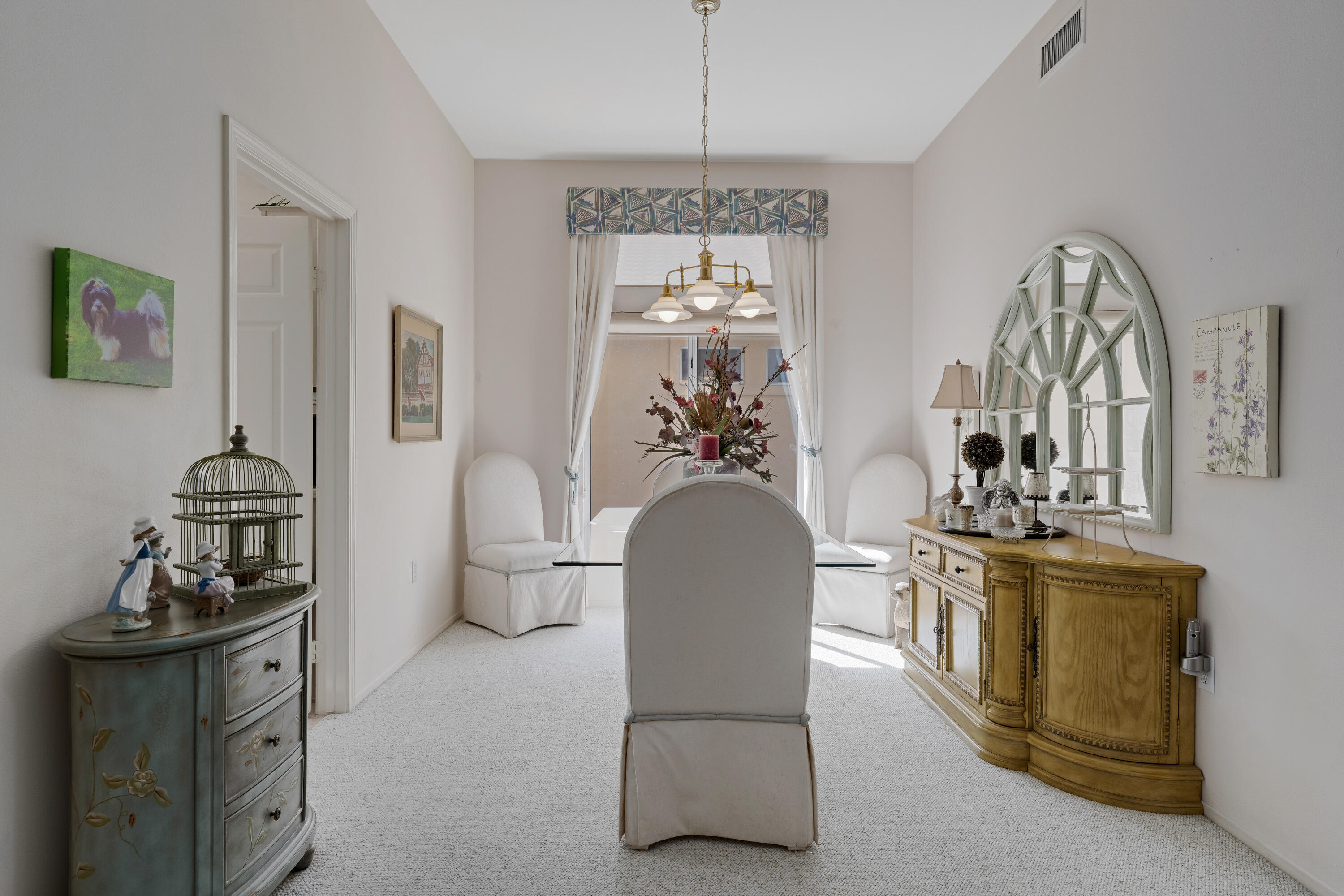 78274 Rainbow Drive Palm Desert, CA 92211 - Photo 10 of 24 a living room with furniture a chandelier and a mirror