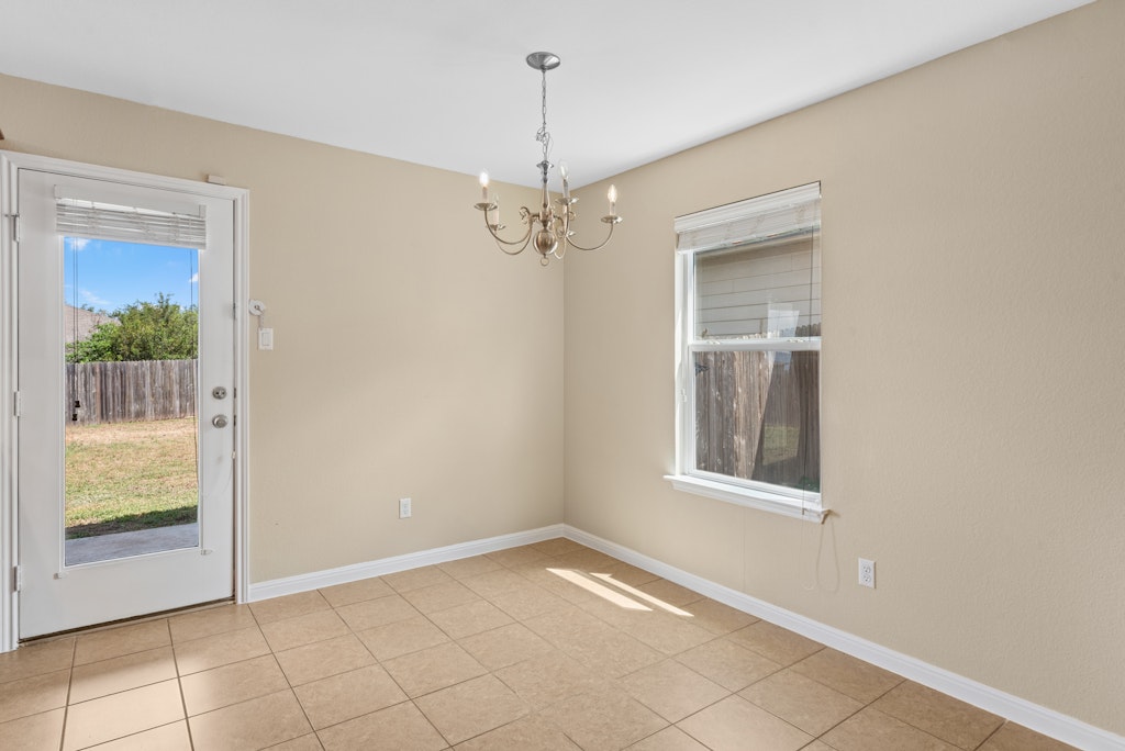 458 Nottingham Loop Kyle, TX 78640 - Photo 10 of 38 a view of an empty room with window and chandelier fan