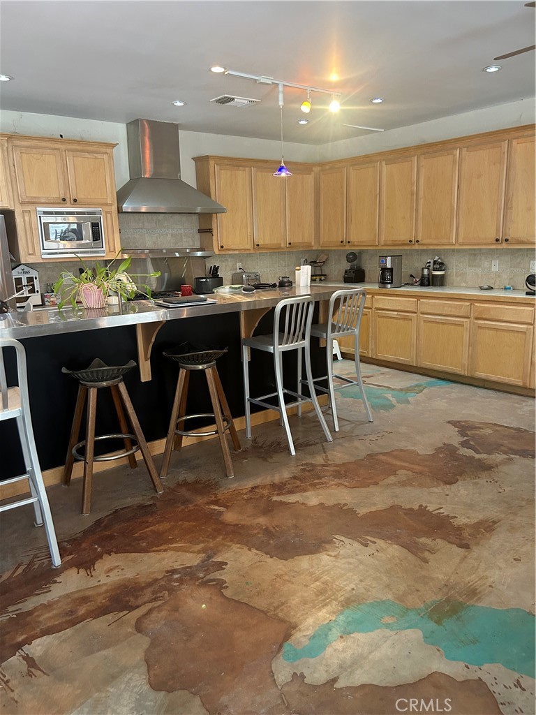 77517 Lowes Canyon Road San Miguel, CA 93451 - Photo 9 of 20 a kitchen with kitchen island granite countertop wooden cabinets and center island