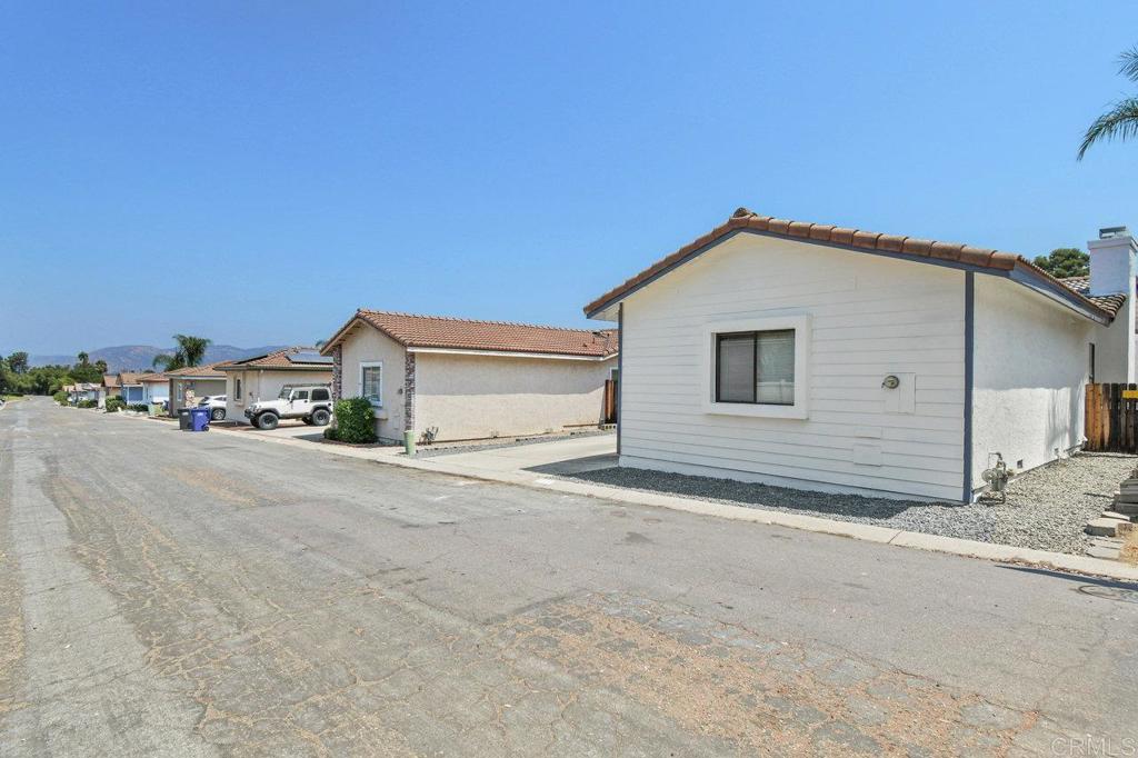 8409 Sleepy Way El Cajon, CA 92021 - Photo 2 of 31 a view of parking area and a house