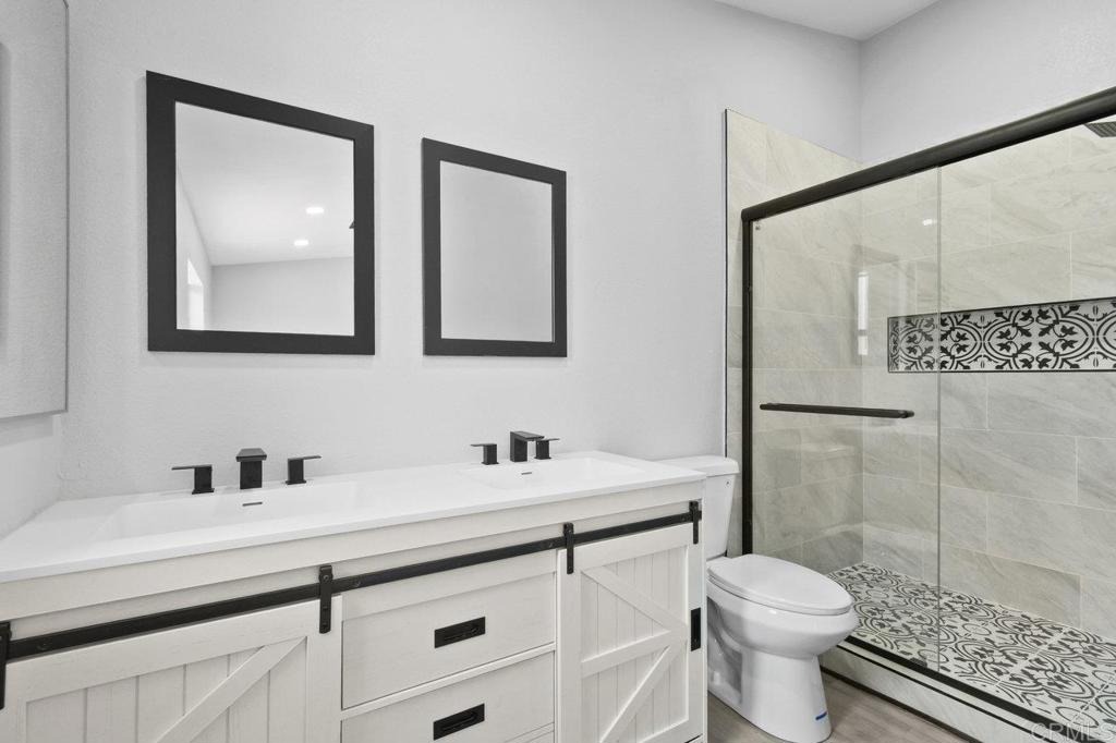 8409 Sleepy Way El Cajon, CA 92021 - Photo 23 of 31 a bathroom with a sink a toilet and a mirror