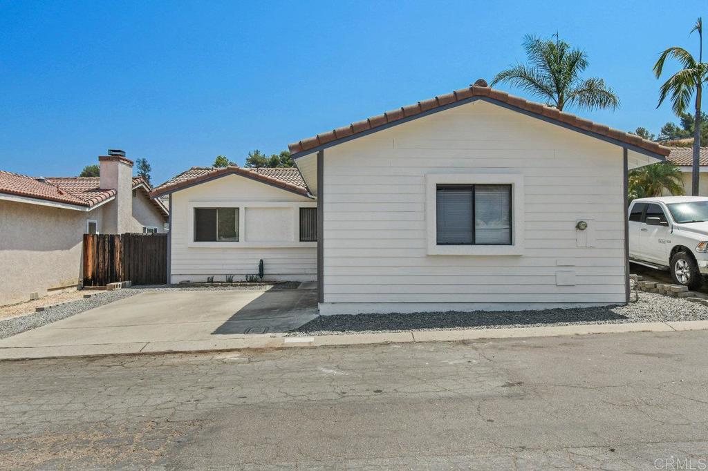 8409 Sleepy Way El Cajon, CA 92021 - Photo 3 of 31 a view of a house with a yard and garage