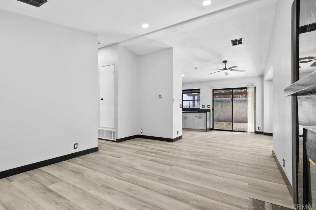 8409 Sleepy Way El Cajon, CA 92021 - Photo 8 of 31 a view of an empty room with window and wooden floor