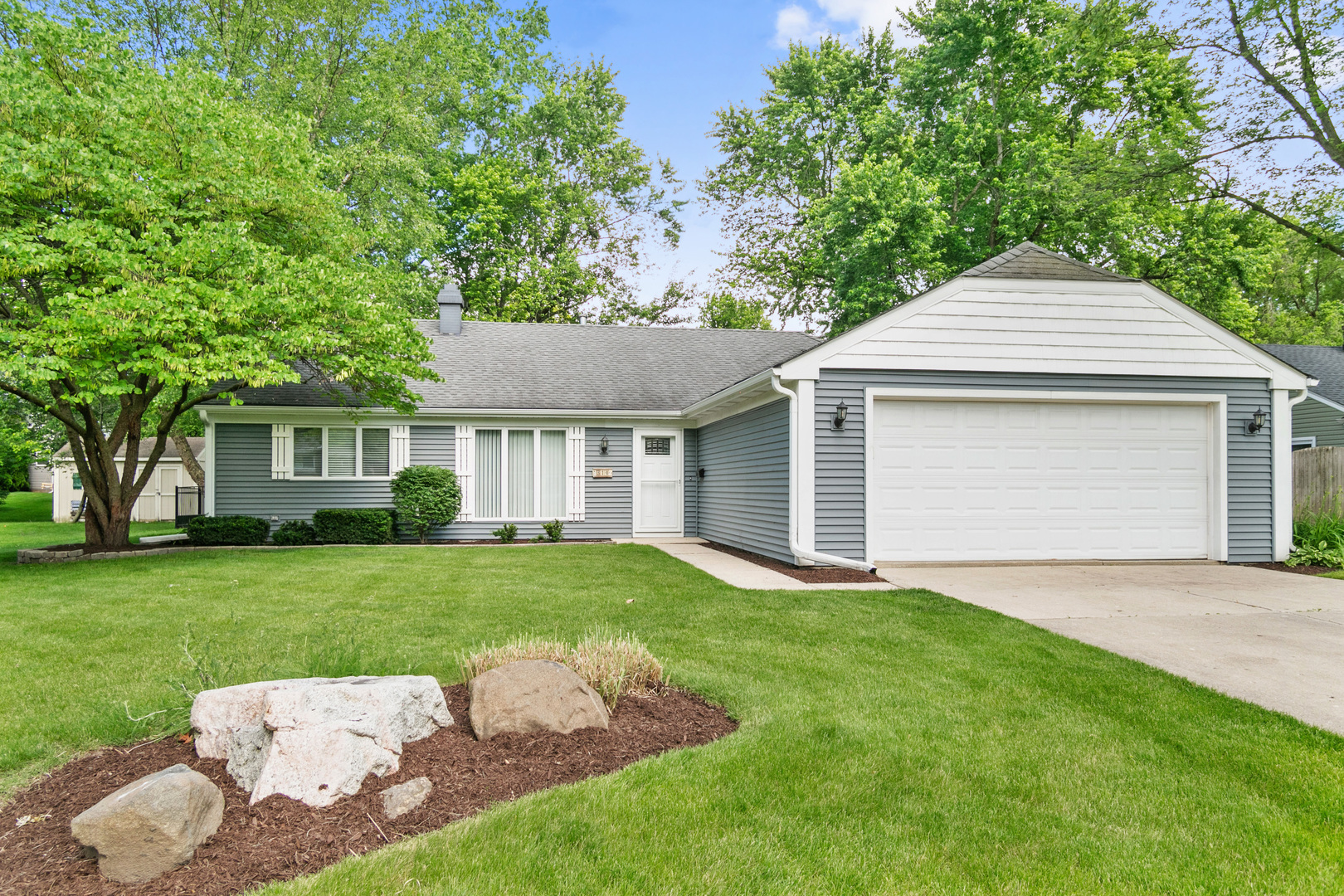 314 Boulder Hill Pass Montgomery, IL 60538 - Photo 1 of 19 a front view of a house with a yard and garage