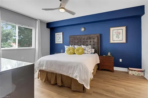 a bedroom with a bed and wooden floor