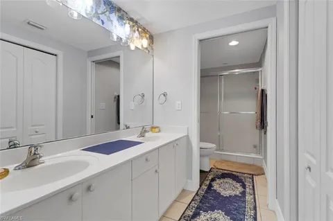 a spacious bathroom with a granite countertop sink mirror and a