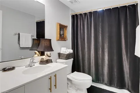 a bathroom with a sink toilet and vanity