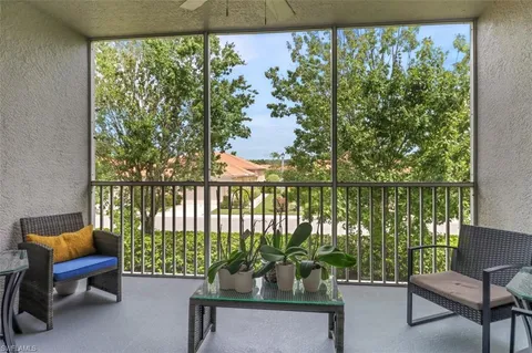 a living room filled with furniture and a potted plant