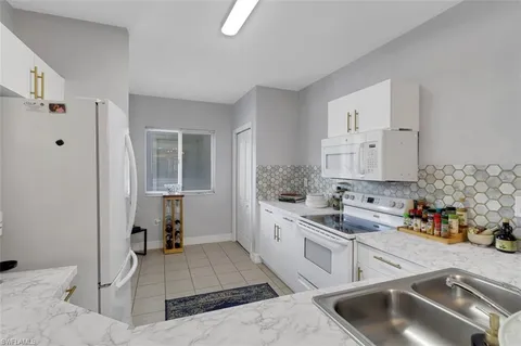 a kitchen that has a sink and a stove in it