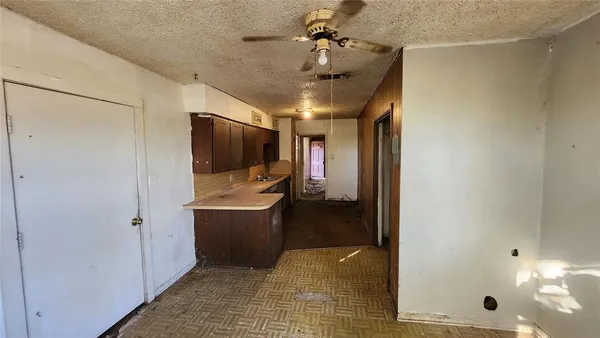 a kitchen with granite countertop a sink and a refrigerator