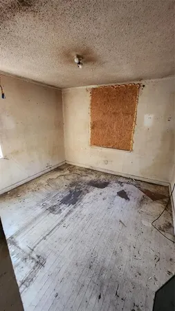 a view of empty room with a fireplace