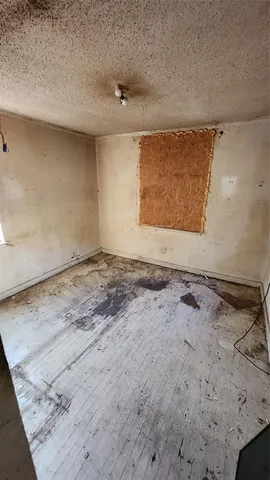 a view of empty room with a fireplace