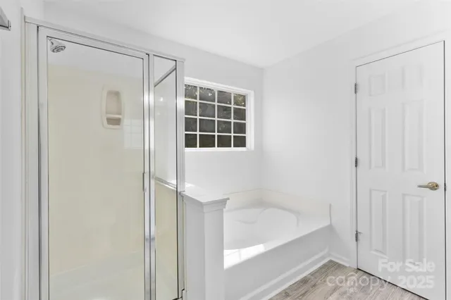 a bathroom with a bathtub and a shower