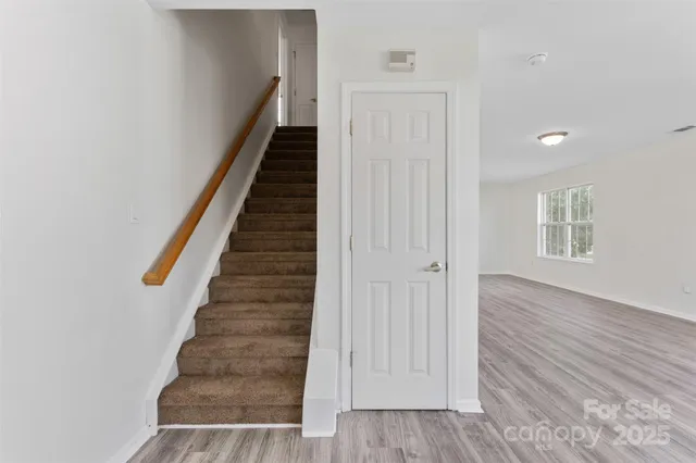 a view of an entryway with wooden floor and stairs