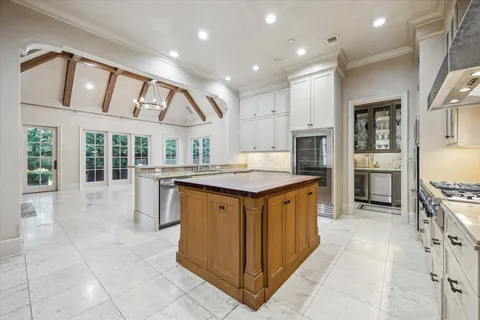 a kitchen with stainless steel appliances granite countertop a stove a sink and a refrigerator
